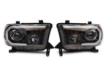 Load image into Gallery viewer, Raxiom 07-13 Toyota Tundra Axial Projector Headlights w/ SEQL LED Bar- Black Housing (Clear Lens)