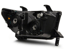 Load image into Gallery viewer, Raxiom 07-13 Toyota Tundra Axial Series Projector Headlights w/ LED Bar- Black Housing (Clear Lens)
