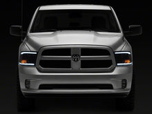 Load image into Gallery viewer, Raxiom 09-18 Dodge RAM 1500/2500/3500 Axial Headlights w/ SEQL LED Bar- Black Housing (Clear Lens)